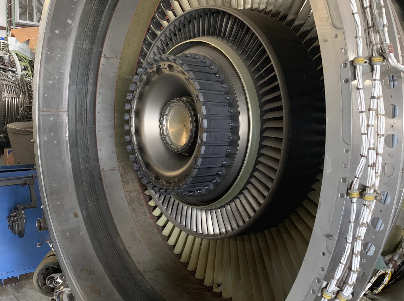 A close-up of a commercial turbofan's fan and core stages during technical inspection